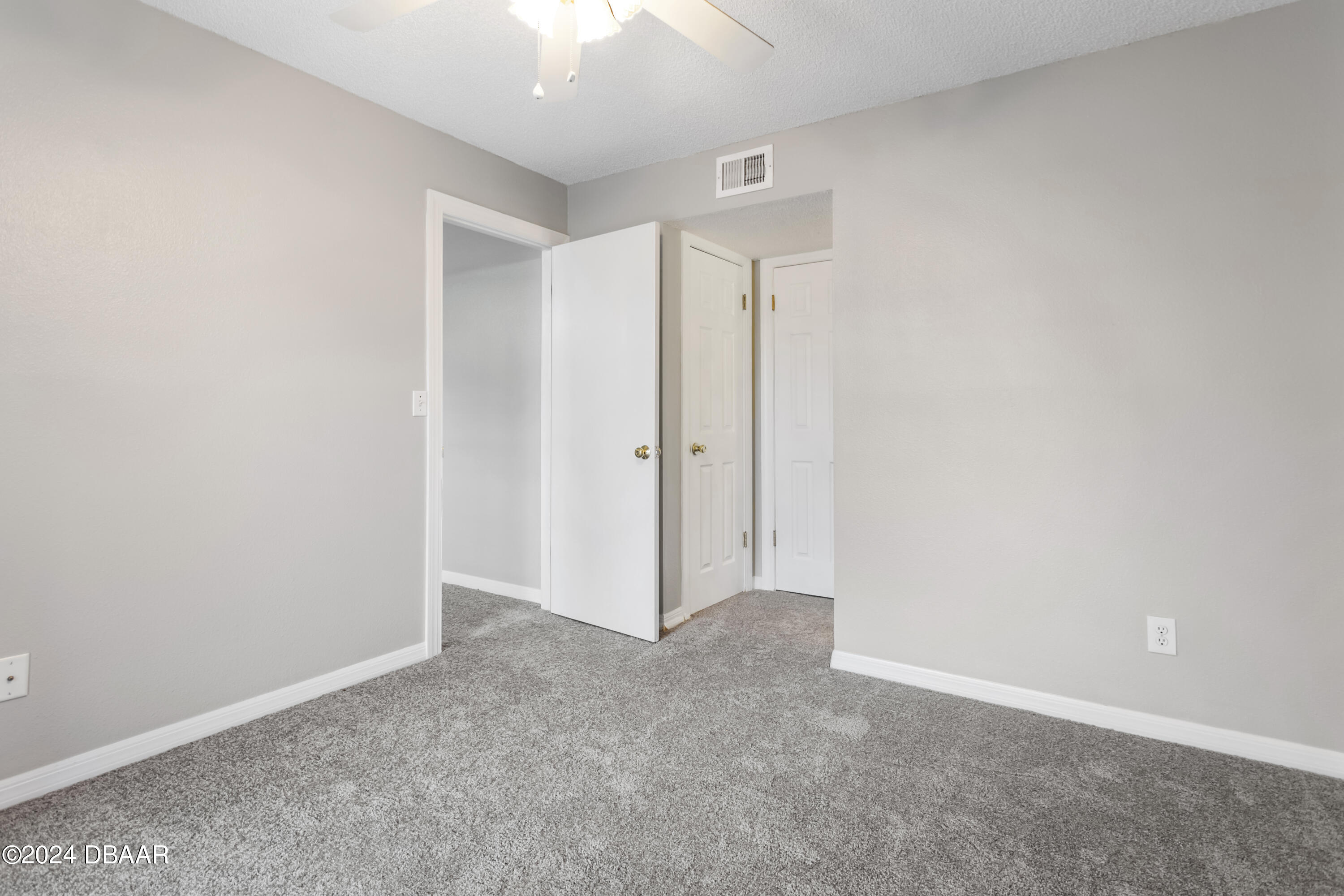 1600 Big Tree Road, Unit K1 South Daytona, FL 32119 - Photo 18 of 28 an empty room with a ceiling fan
