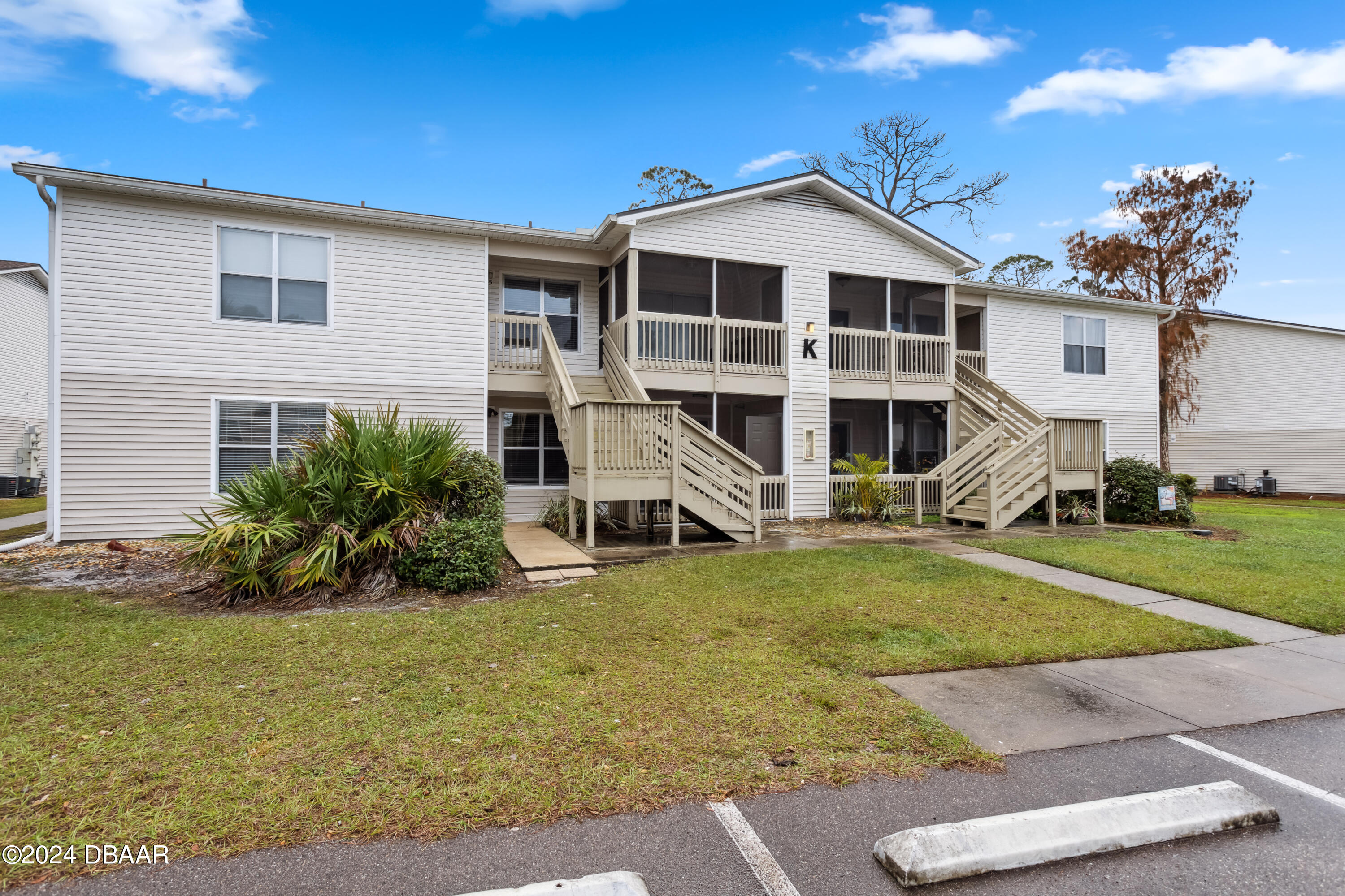 1600 Big Tree Road, Unit K1 South Daytona, FL 32119 - Photo 2 of 28 a front view of a house with a yard