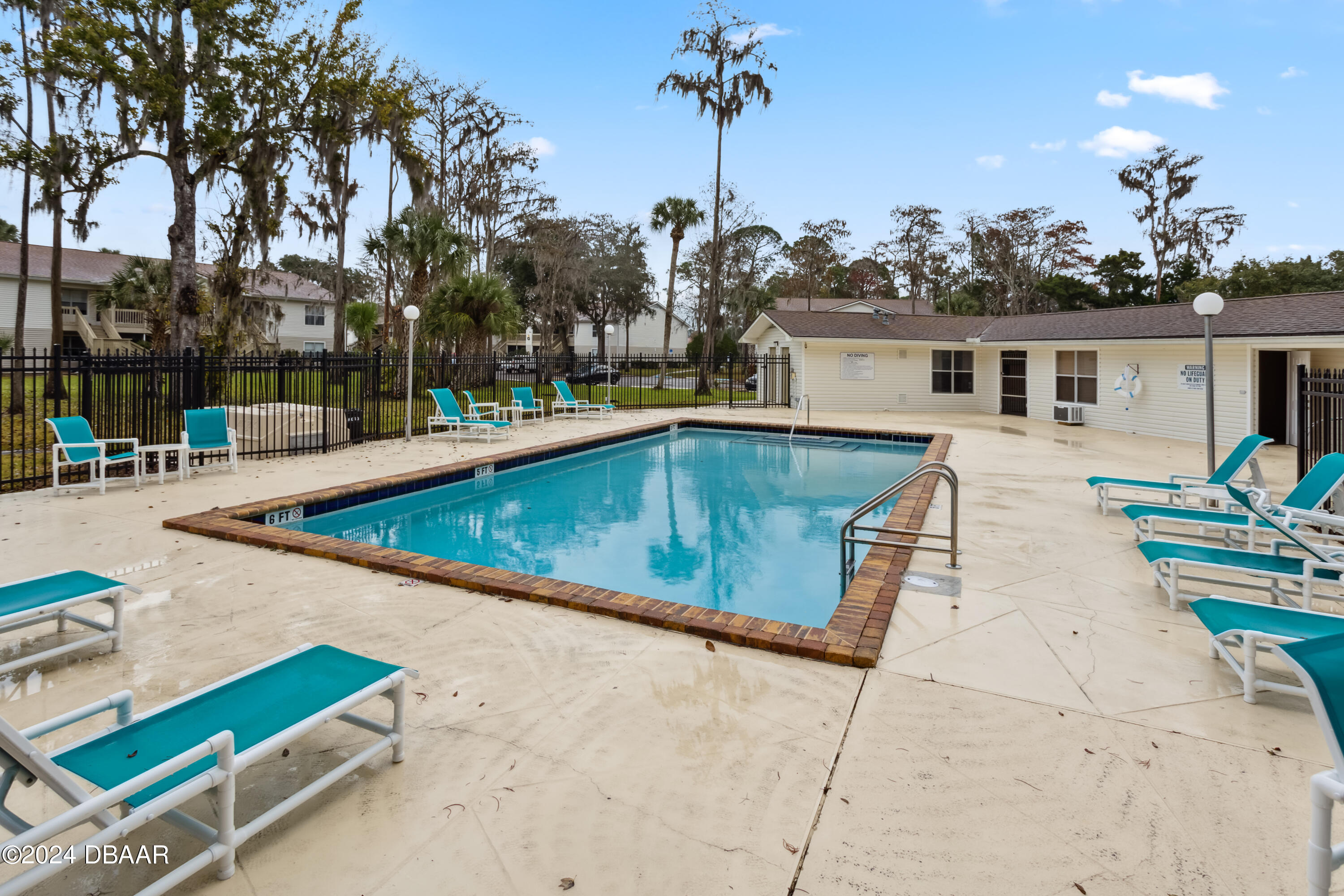 1600 Big Tree Road, Unit K1 South Daytona, FL 32119 - Photo 4 of 28 a view of a house with pool and chairs
