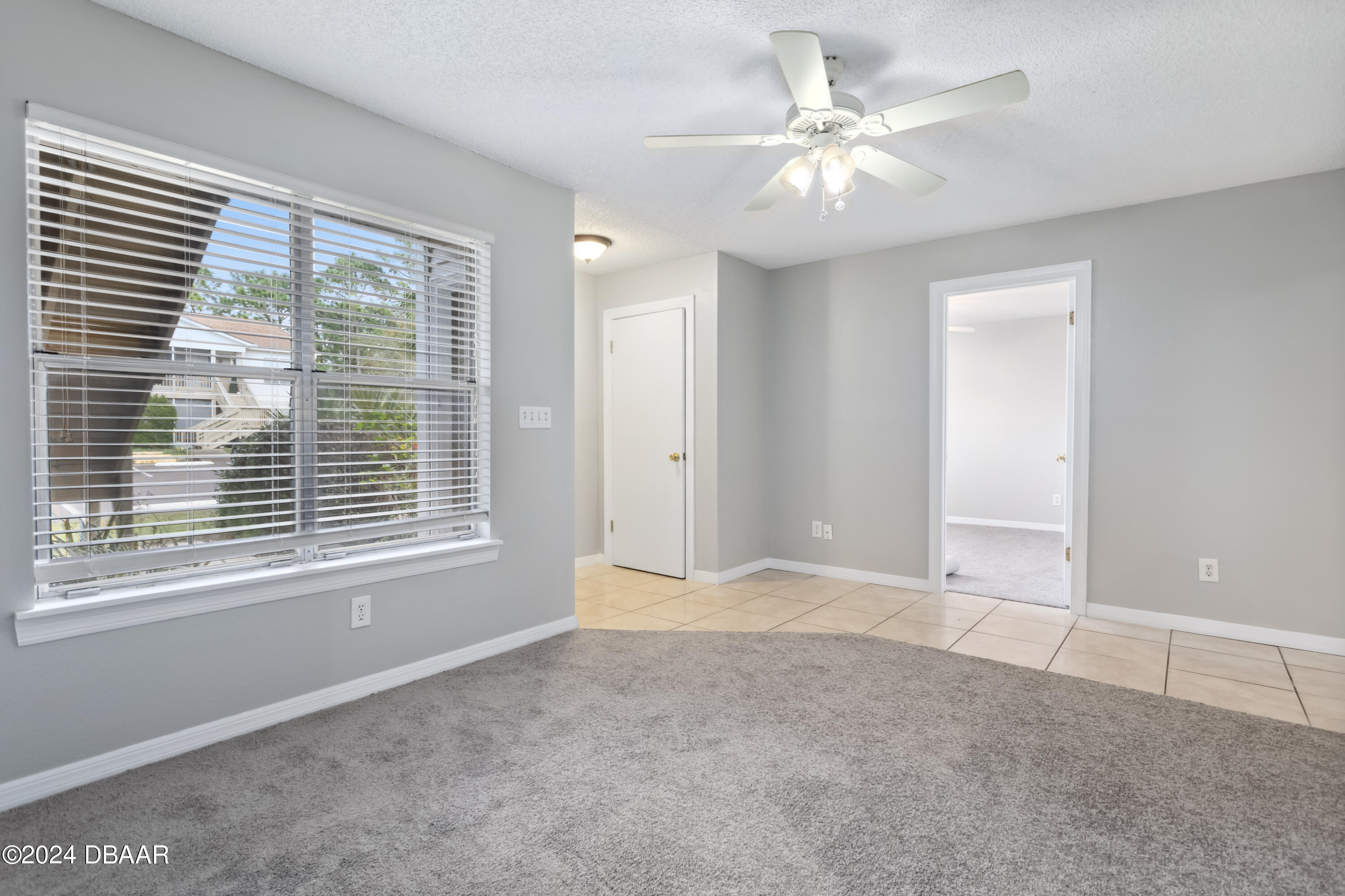 1600 Big Tree Road, Unit K1 South Daytona, FL 32119 - Photo 9 of 28 a view of an empty room with a window and a ceiling fan