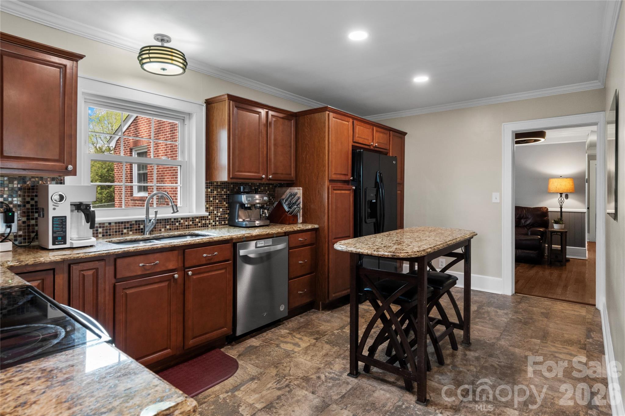 734 Oakland Drive Elkin, NC 28621 - Photo 12 of 48 a kitchen with stainless steel appliances granite countertop table chairs sink and cabinets