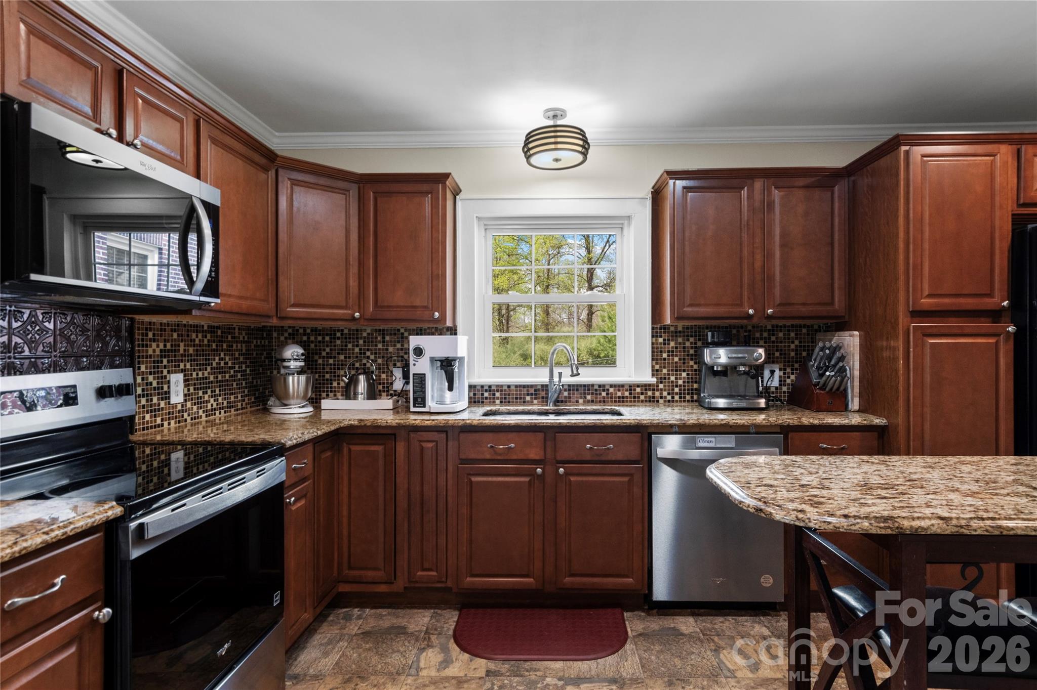 734 Oakland Drive Elkin, NC 28621 - Photo 13 of 48 a kitchen with stainless steel appliances granite countertop a stove a sink dishwasher and cabinets with wooden floor