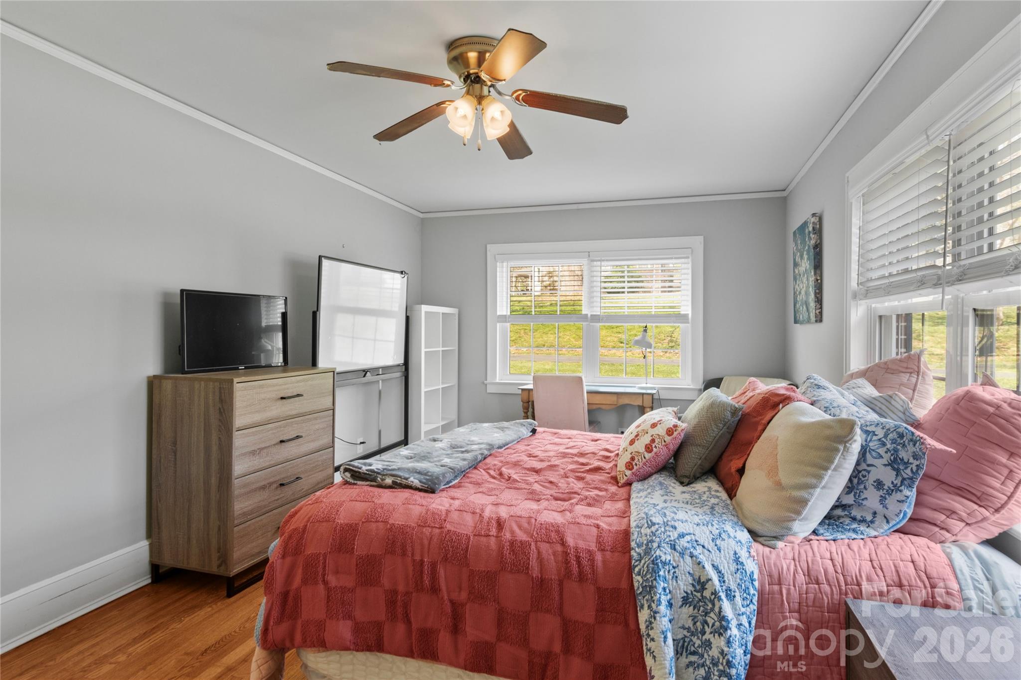 734 Oakland Drive Elkin, NC 28621 - Photo 27 of 48 a bedroom with a large bed and a flat tv screen on dresser