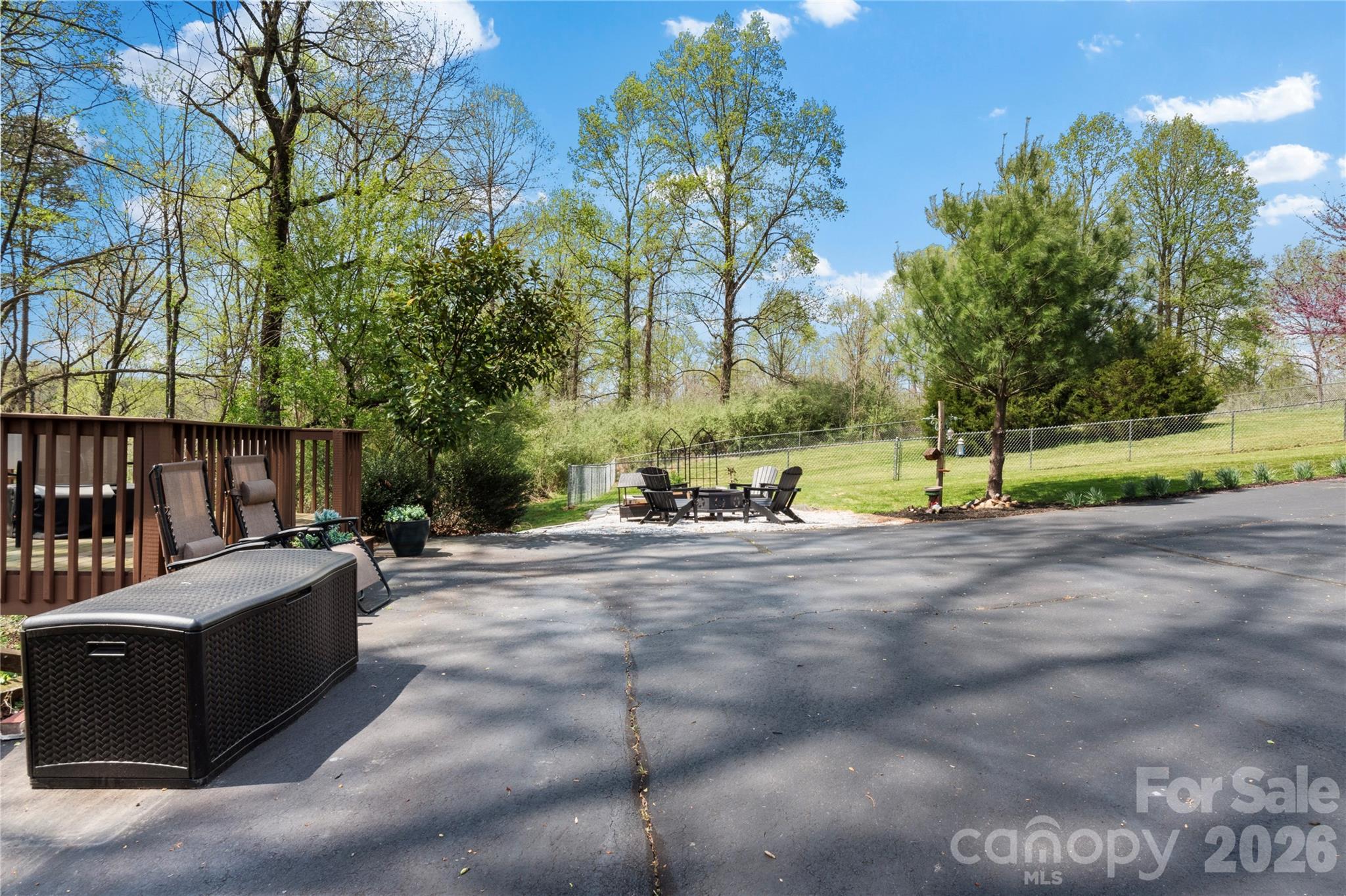 734 Oakland Drive Elkin, NC 28621 - Photo 36 of 48 a view of a backyard with large tree and wooden fence
