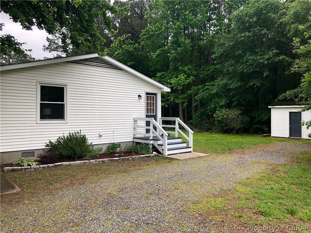 962 Ottoman Ferry Road Lancaster, VA 22503 - Photo 3 of 24 a view of a house with backyard and trees