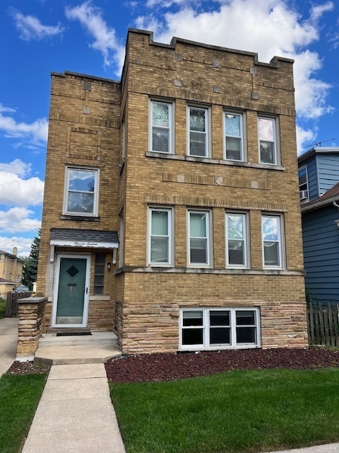 1116 Thomas Avenue, Unit G Forest Park, IL 60130 - Photo 1 of 9 a front view of a house with garden