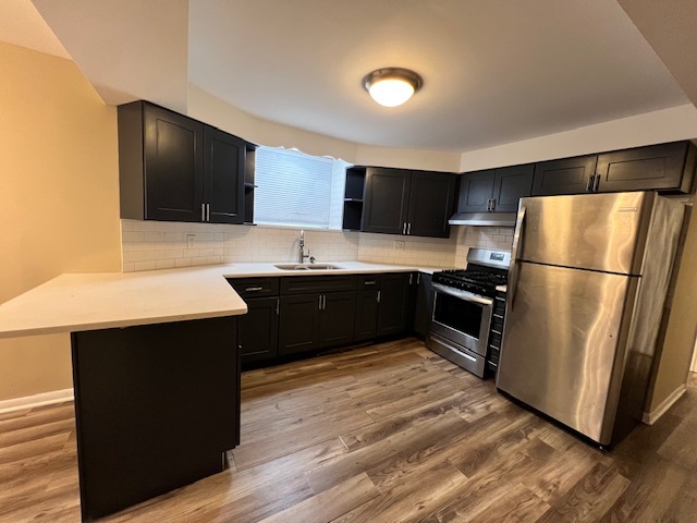 1116 Thomas Avenue, Unit G Forest Park, IL 60130 - Photo 2 of 9 a kitchen with stainless steel appliances a refrigerator and a sink