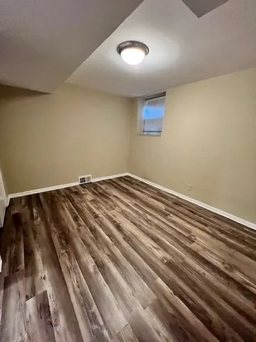 a view of a room with wooden floor and carpet