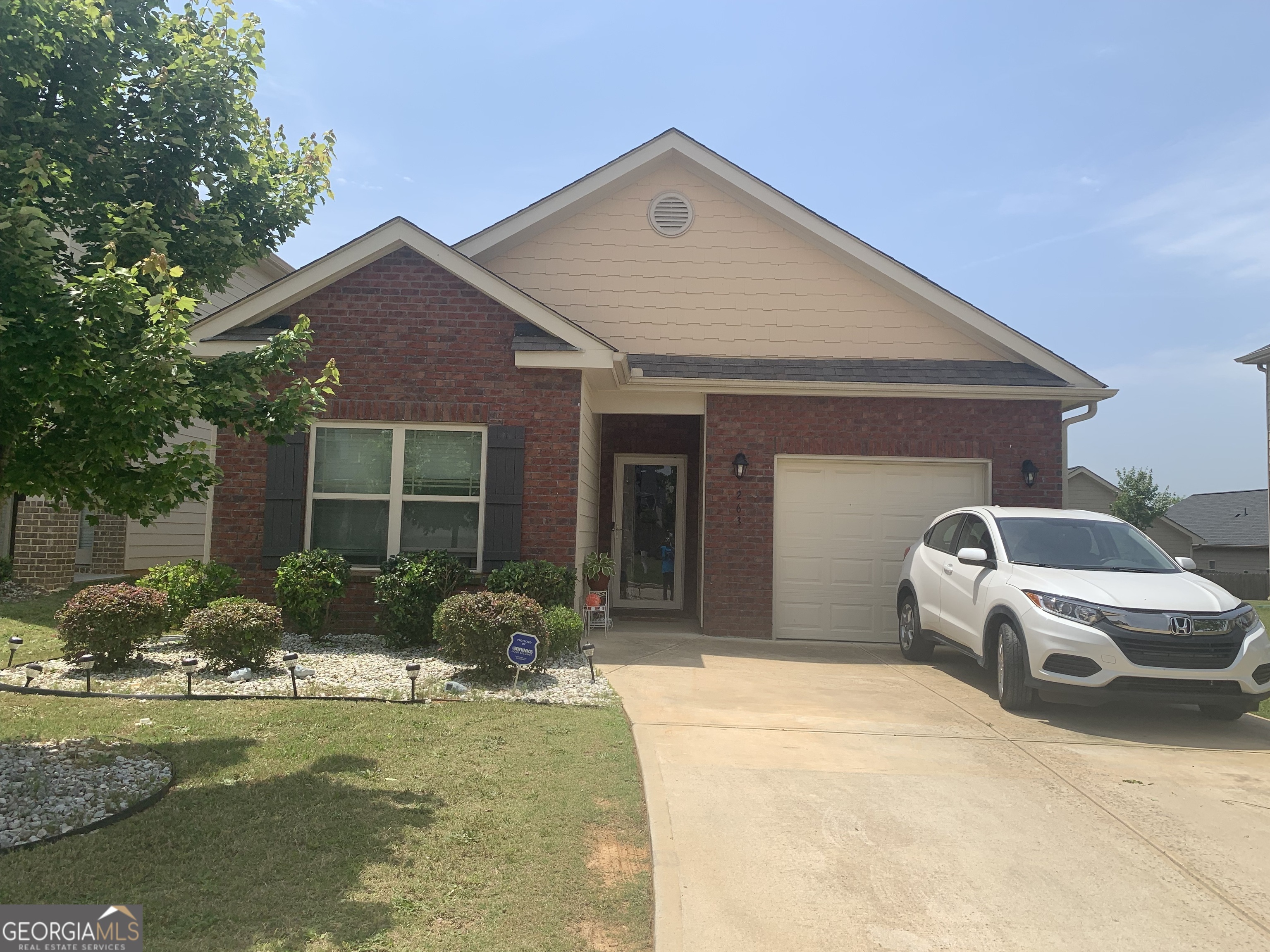 2635 Lovejoy Crossing Lane Hampton, GA 30228 - Photo 1 of 14 a front view of a house with garden