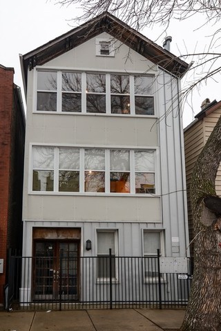 a front view of a house with glass windows