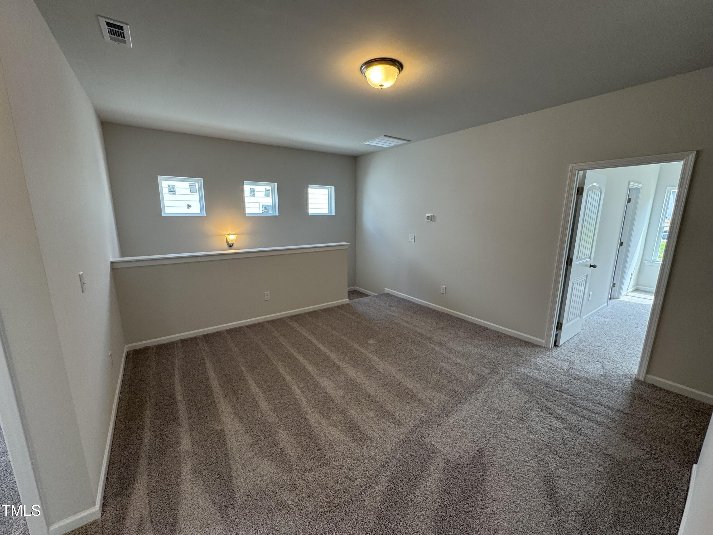 51 Commons Circle Clayton, NC 27520 - Photo 11 of 31 wooden floor in an empty room with a window