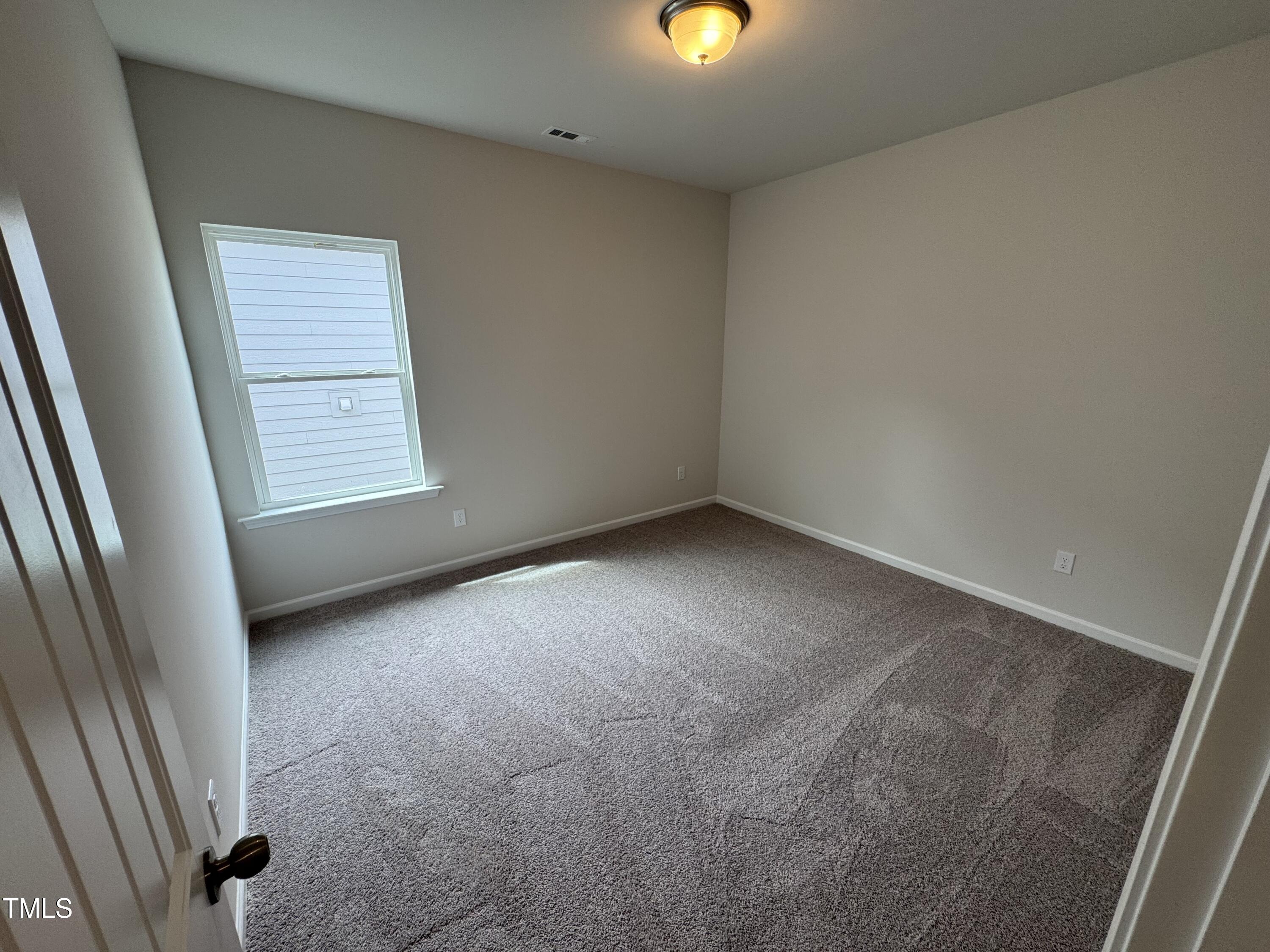 51 Commons Circle Clayton, NC 27520 - Photo 12 of 31 an empty room with a window