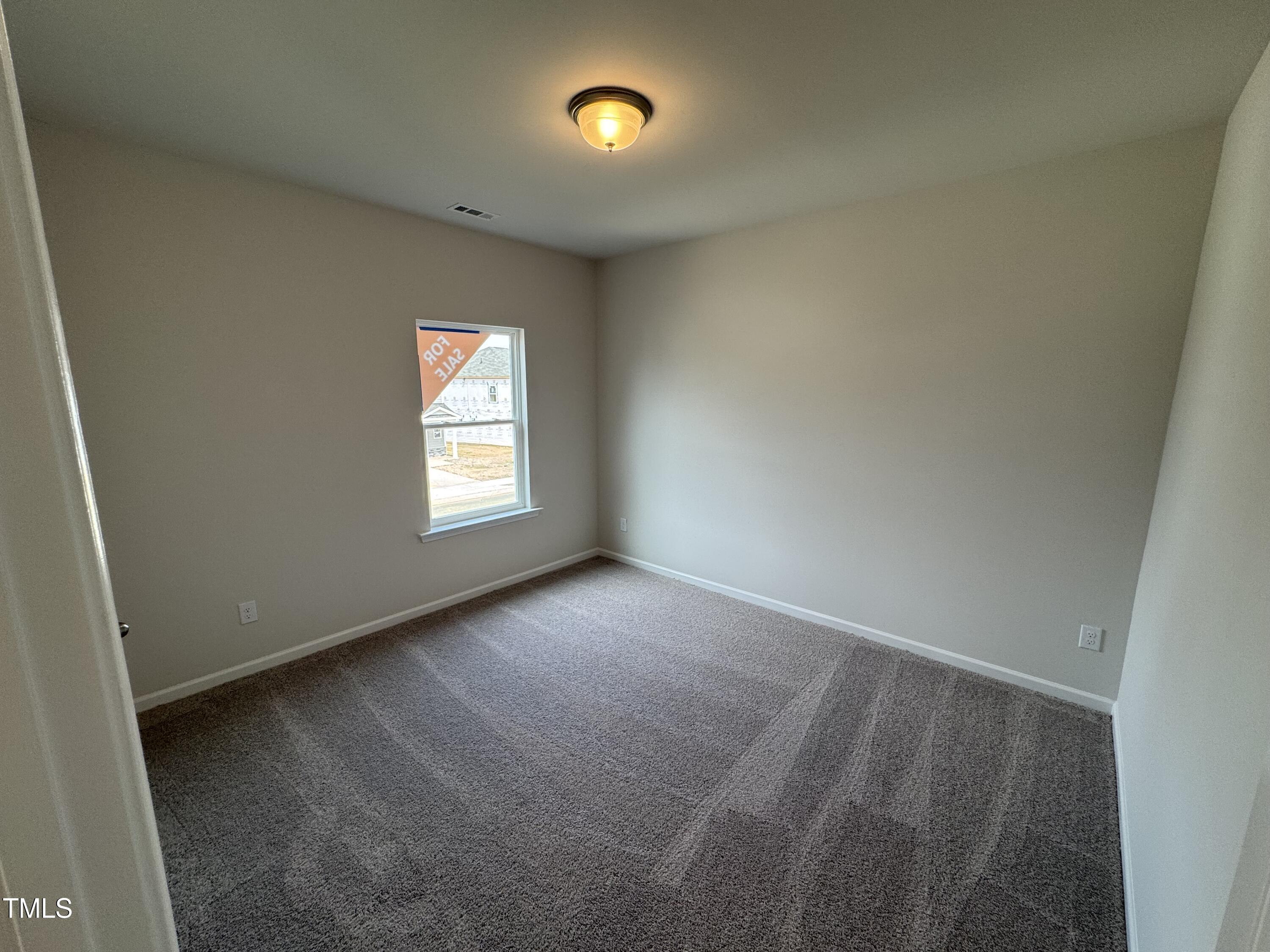 51 Commons Circle Clayton, NC 27520 - Photo 13 of 31 an empty room with windows and air conditioner duct