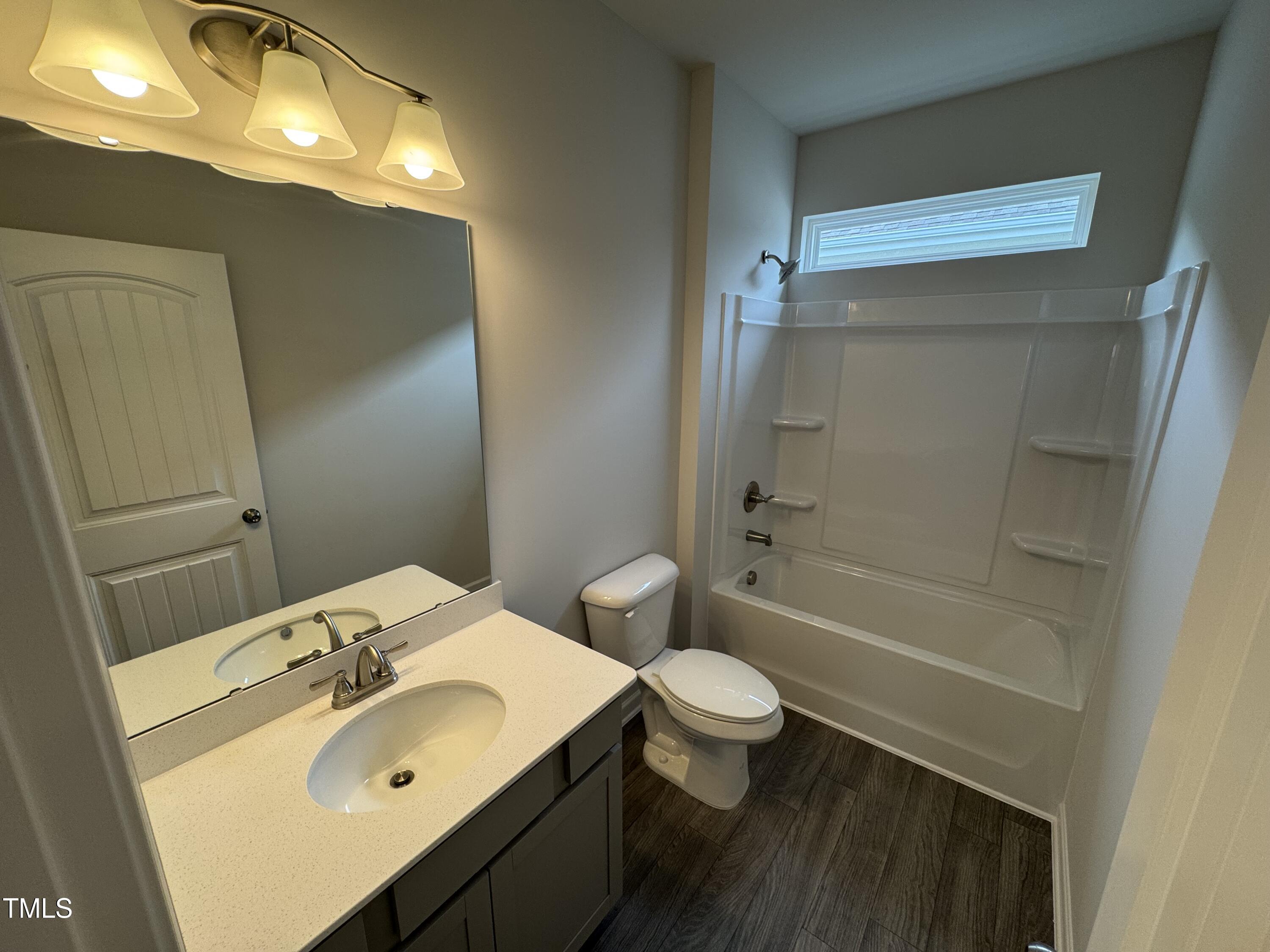 51 Commons Circle Clayton, NC 27520 - Photo 14 of 31 a bathroom with a sink toilet and shower