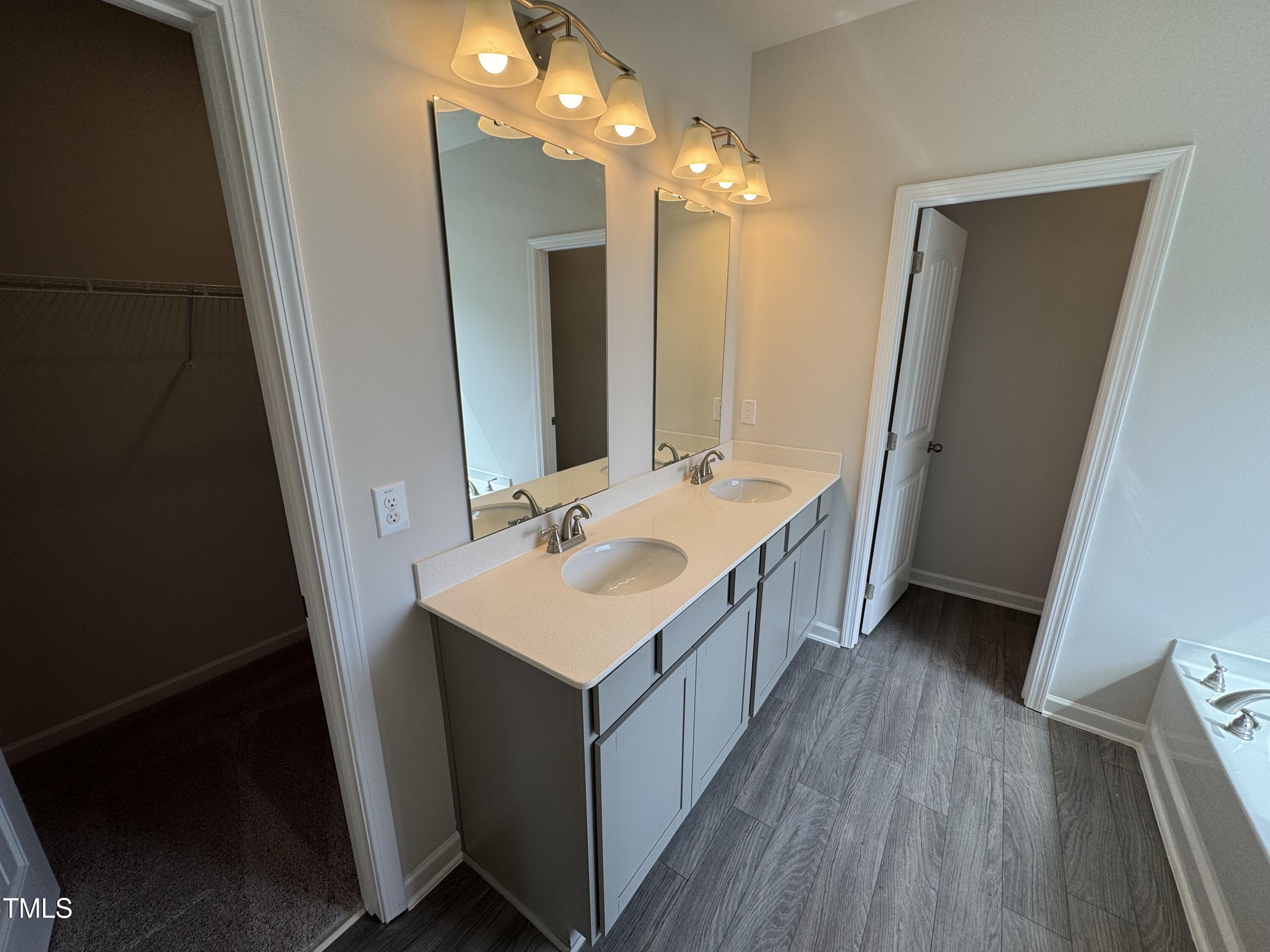 51 Commons Circle Clayton, NC 27520 - Photo 19 of 31 a bathroom with a double vanity sink mirror and vanity