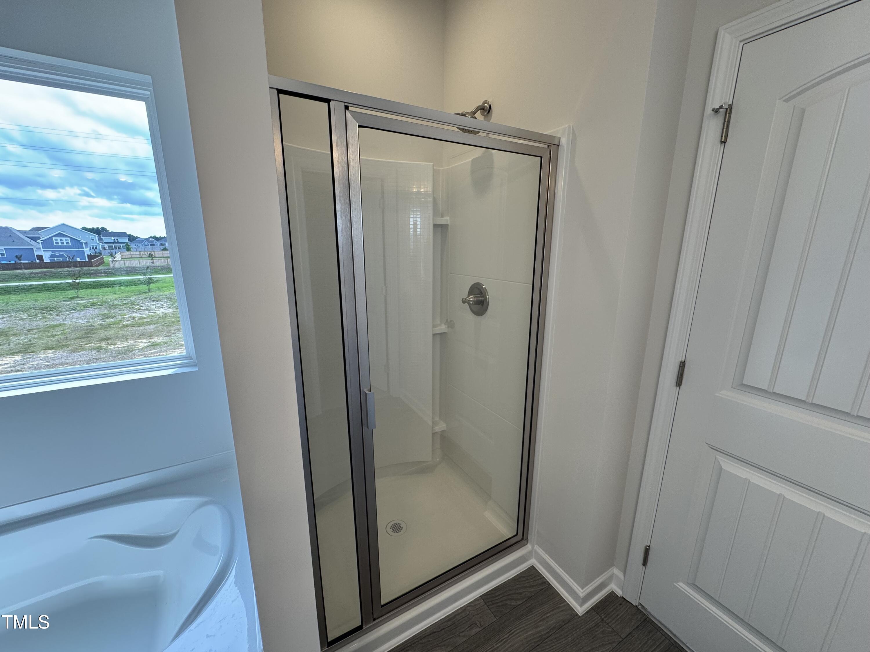 51 Commons Circle Clayton, NC 27520 - Photo 20 of 31 a bathroom with a glass shower door