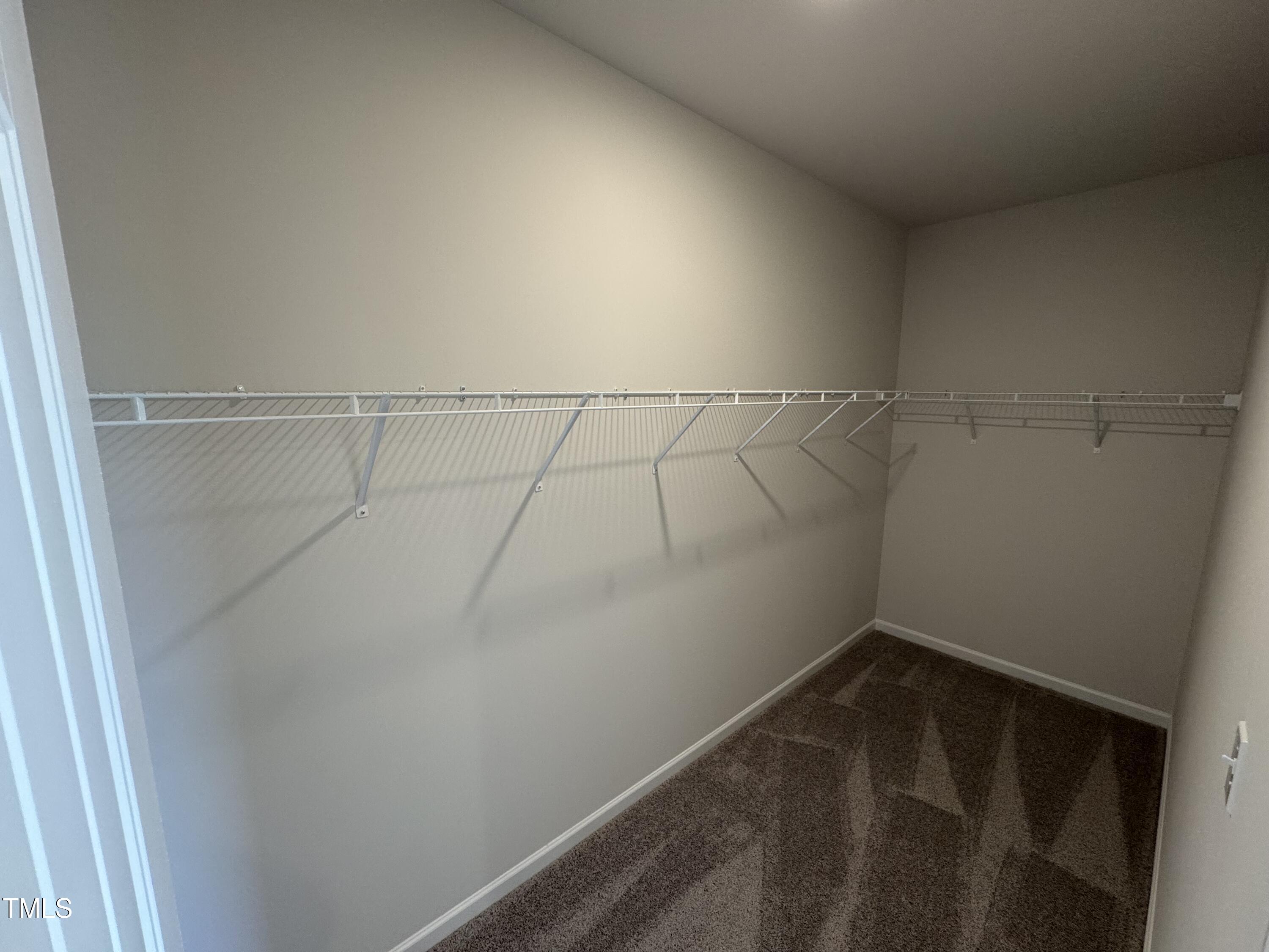 51 Commons Circle Clayton, NC 27520 - Photo 21 of 31 a view of a room with racks on the wall