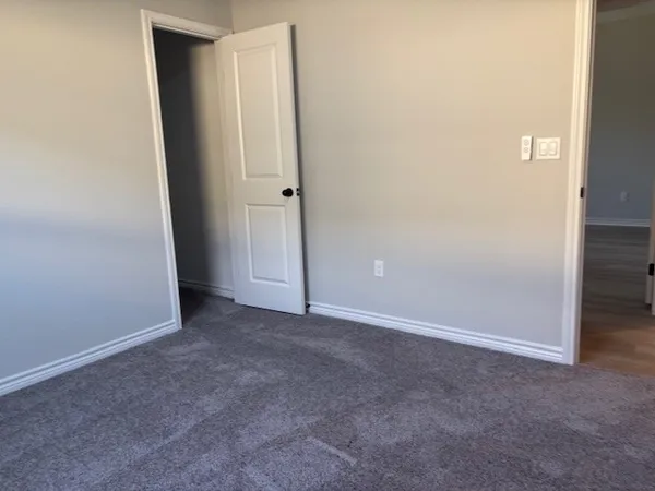 an empty room with closet area