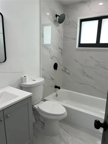 a bathroom with a toilet sink and shower