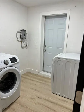a view of a hallway with washer and dryer