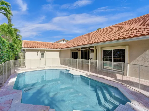 a view of house with backyard space and balcony