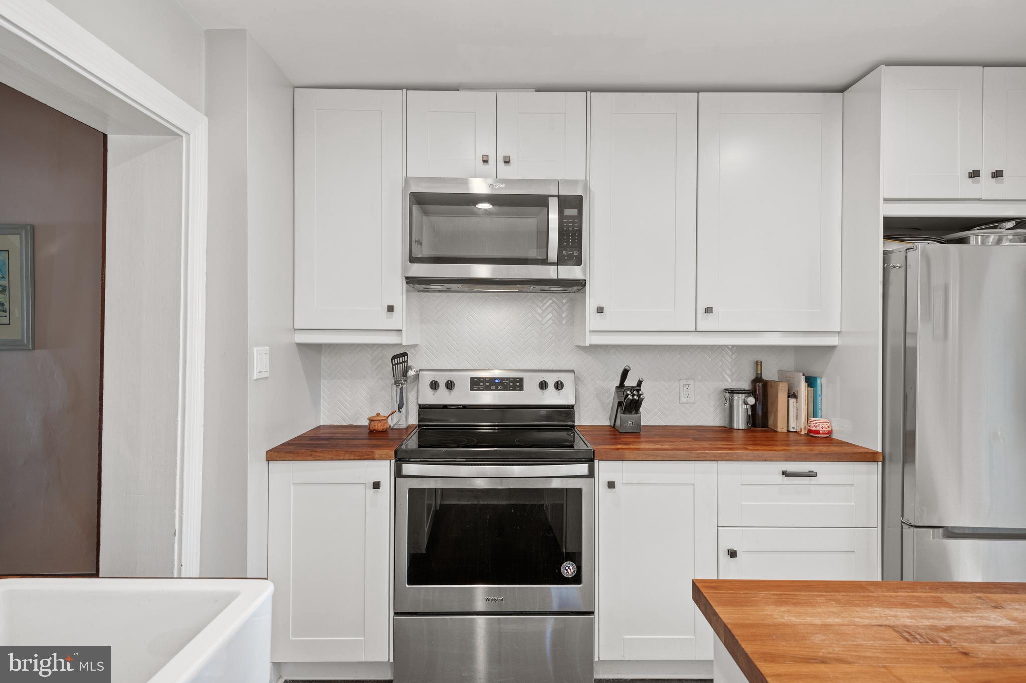 156 Front Street Lititz, PA 17543 - Photo 28 of 58 a kitchen with stainless steel appliances granite countertop a stove and a refrigerator