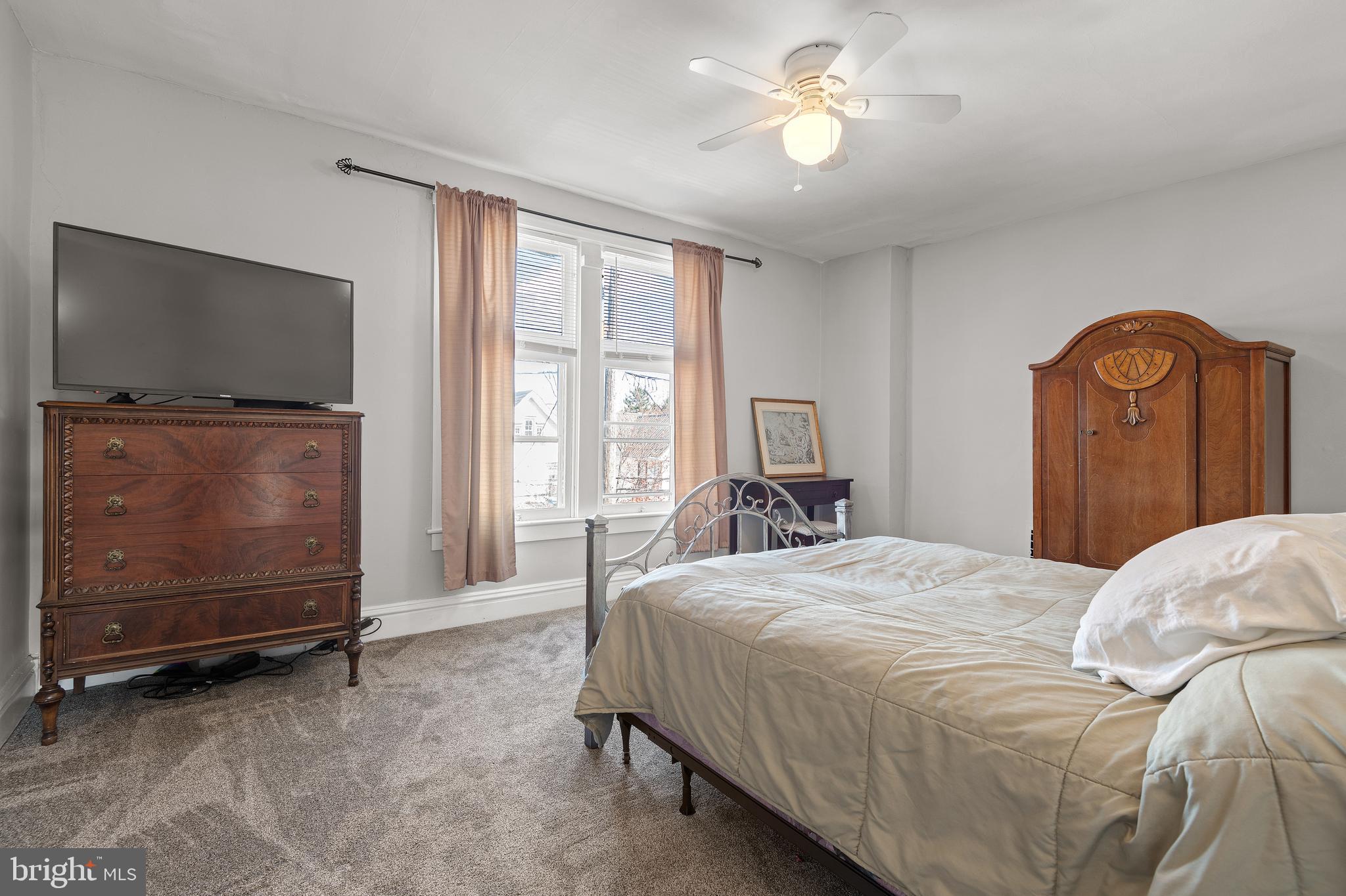 156 Front Street Lititz, PA 17543 - Photo 40 of 58 a bedroom with a bed and a flat tv screen on dresser