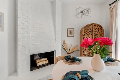 a dining room with furniture and flower pot
