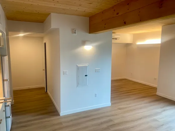 a view of a hallway with wooden floor