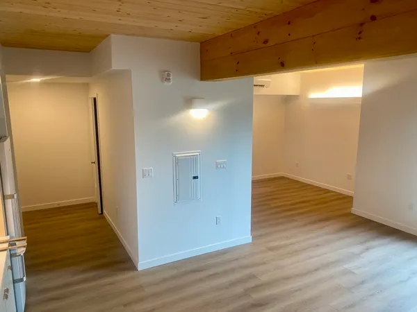 a view of a room with wooden floor