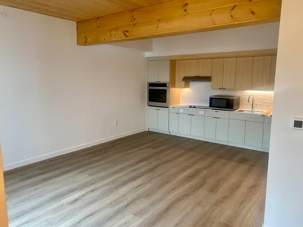 a view of a kitchen with a sink and a refrigerator