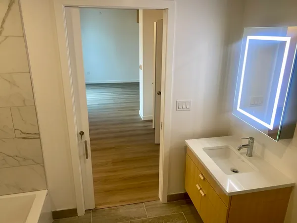 a bathroom with a sink a mirror and shower