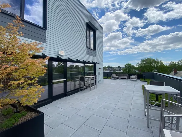 a view of house with backyard and sitting area