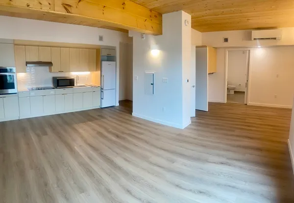 a view of a kitchen with a sink and wooden floor