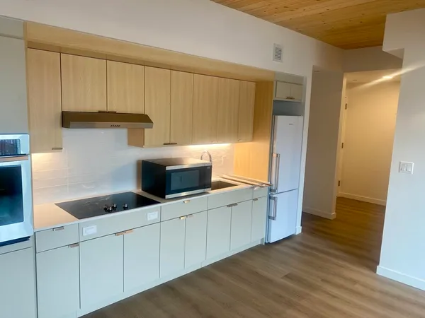 a kitchen with stainless steel appliances a white cabinets and sink