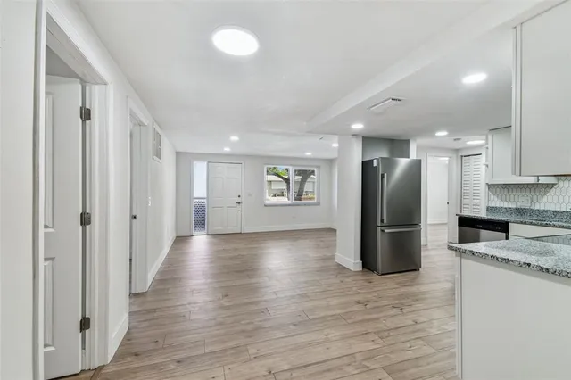 a kitchen with stainless steel appliances granite countertop a refrigerator stove microwave and sink