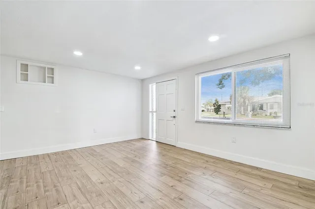 a kitchen with granite countertop white cabinets and black appliances