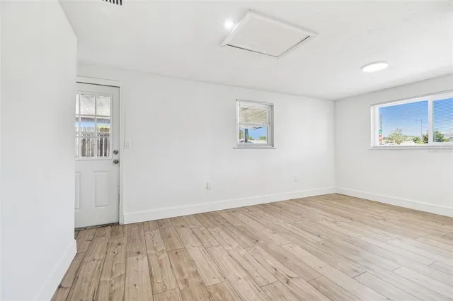 a view of an empty room with wooden floor