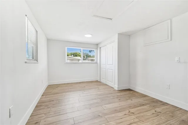 a bathroom with a toilet a sink a mirror a bathtub and vanity