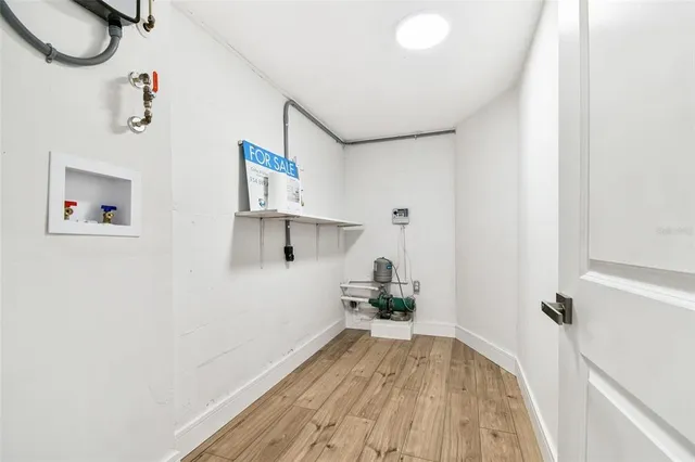 a bedroom with bed and a potted plant