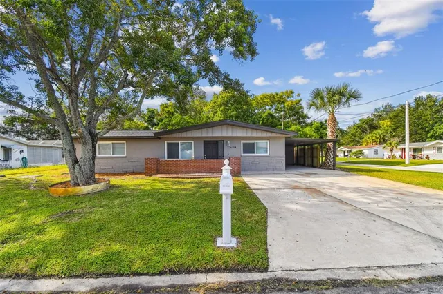a view of backyard with swimming pool and outdoor seating