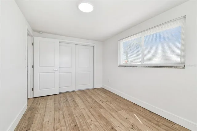 a view of wooden floor and windows in a room