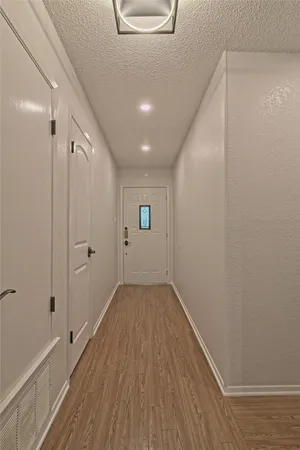 a view of hallway with wooden floor