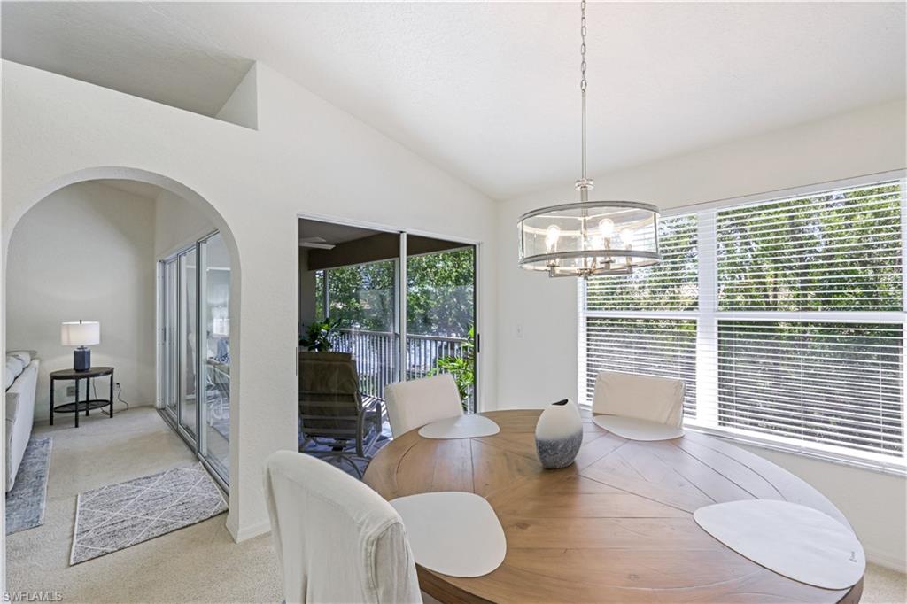 386 Emerald Bay Circle, Unit G4 Naples, FL 34110 - Photo 11 of 22 a living room with furniture and a floor to ceiling window