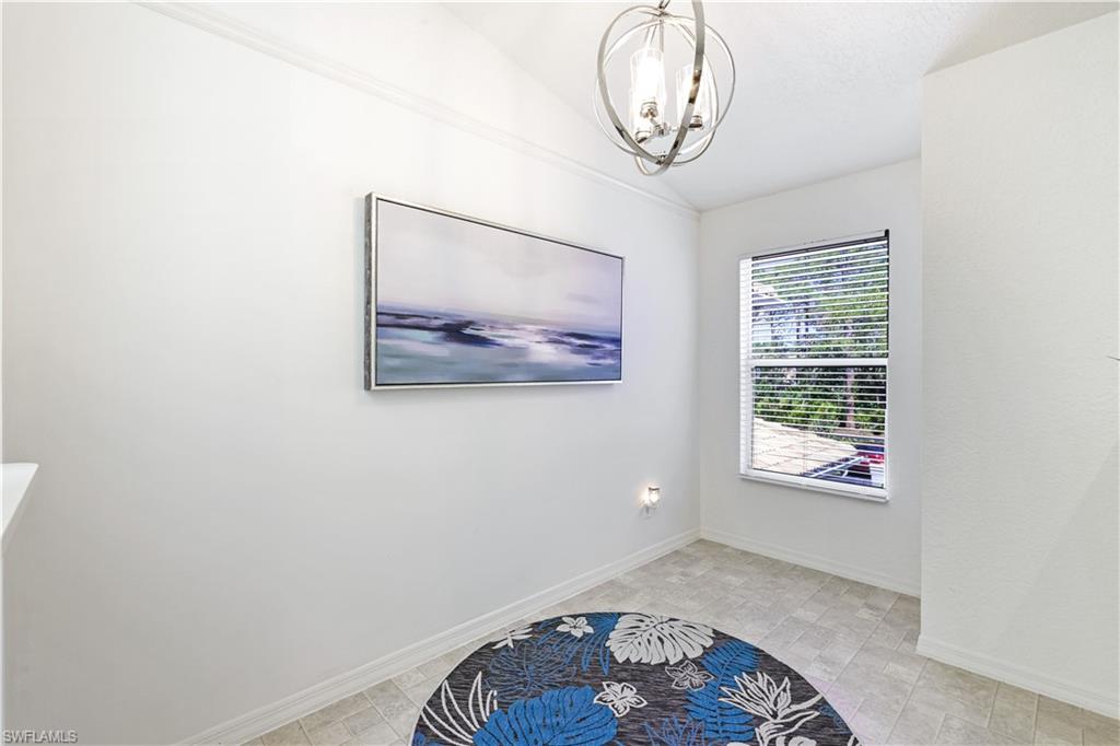 386 Emerald Bay Circle, Unit G4 Naples, FL 34110 - Photo 12 of 22 a view of room with window and wooden floor