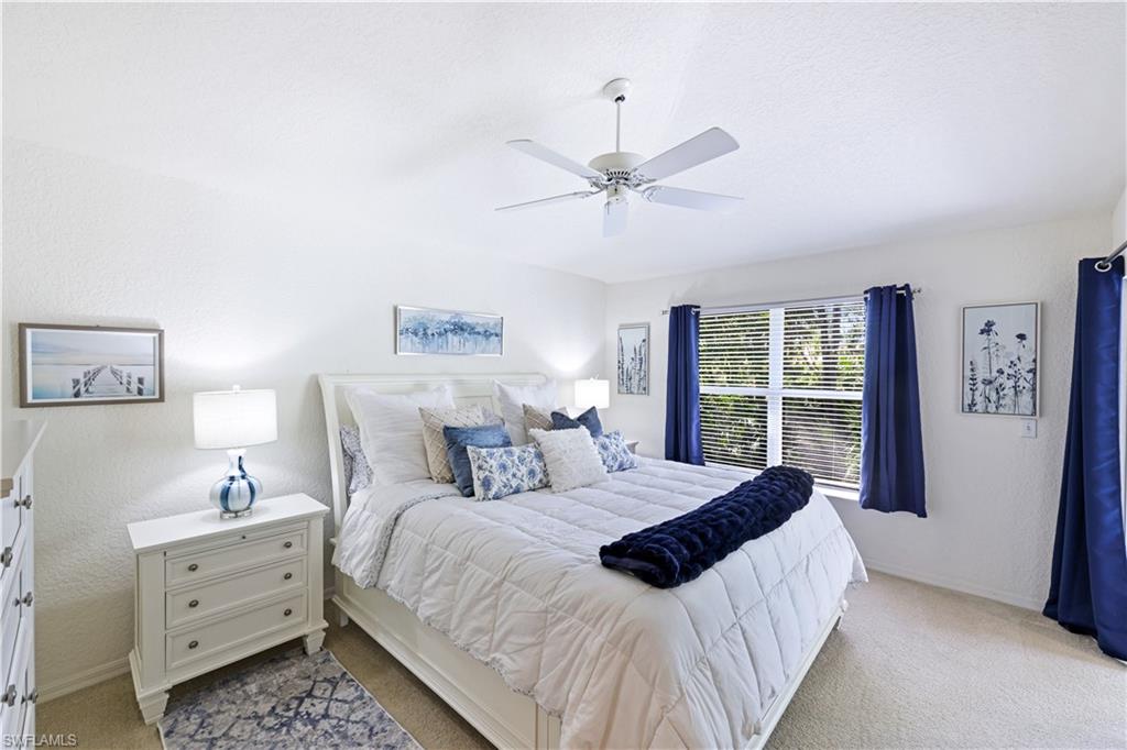 386 Emerald Bay Circle, Unit G4 Naples, FL 34110 - Photo 14 of 22 a bedroom with a large bed and a window