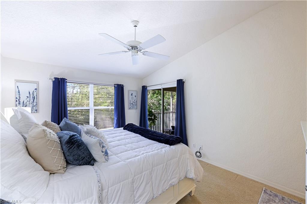 386 Emerald Bay Circle, Unit G4 Naples, FL 34110 - Photo 15 of 22 a bedroom with a large bed and a window