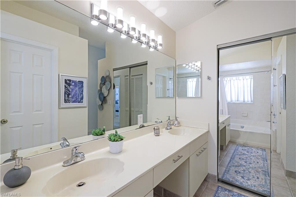 386 Emerald Bay Circle, Unit G4 Naples, FL 34110 - Photo 17 of 22 a bathroom with a sink double vanity and a mirror