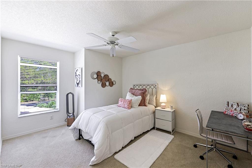 386 Emerald Bay Circle, Unit G4 Naples, FL 34110 - Photo 18 of 22 a bed room with a bed and a chair