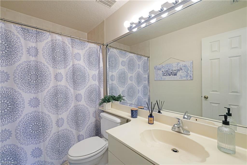 386 Emerald Bay Circle, Unit G4 Naples, FL 34110 - Photo 19 of 22 a bathroom with a sink toilet and shower